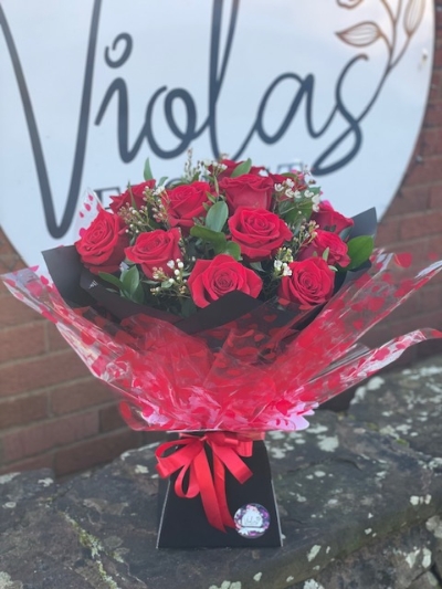 12 romantic premium red roses with wax flowers or gypsophila