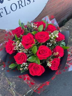 12 romantic premium red roses with wax flowers or gypsophila